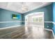 Cozy living room with tray ceiling, ceiling fans, hardwood floors, and an entertainment center at 615 N 17Th Ave. N, Surfside Beach, SC 29575