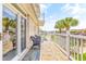 Brick balcony with chairs, white railings, and waterfront views and neighboring buildings at 144 Waterway Crossing Ct., Little River, SC 29566