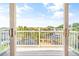 Balcony view of water with boat docks and lush trees surrounding the homes on a sunny day at 144 Waterway Crossing Ct., Little River, SC 29566