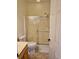Cozy bathroom featuring a glass-enclosed shower and neutral-toned tiles at 144 Waterway Crossing Ct., Little River, SC 29566