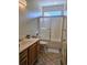 Bathroom featuring a single sink vanity and a shower-tub combination with a sliding glass door at 144 Waterway Crossing Ct., Little River, SC 29566