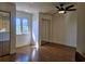 Bright bedroom features wood floors, a ceiling fan, and mirrored closet doors at 144 Waterway Crossing Ct., Little River, SC 29566