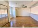 Spacious bedroom features wood floors, a ceiling fan, and mirrored closet doors at 144 Waterway Crossing Ct., Little River, SC 29566