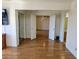 Bright bedroom featuring wood floors, closet, and access to the ensuite bathroom and a secondary room at 144 Waterway Crossing Ct., Little River, SC 29566
