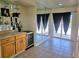 Entertaining space with tile floor, wet bar, wine cooler, mirror wall and access to the balcony at 144 Waterway Crossing Ct., Little River, SC 29566