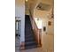 Bright foyer with staircase, chandelier, tile flooring, and an open view to the fireplace and living area at 144 Waterway Crossing Ct., Little River, SC 29566