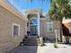 Elegant home exterior featuring a grand entrance with brickwork, large windows and stone stairway at 144 Waterway Crossing Ct., Little River, SC 29566