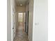 Hallway with tile flooring leading to a bathroom with toilet and walk-in shower at 144 Waterway Crossing Ct., Little River, SC 29566