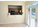 Kitchenette view with wood cabinets, pass through to the kitchen and sliding doors to the porch at 144 Waterway Crossing Ct., Little River, SC 29566