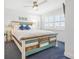 Bedroom with a rustic queen bed, ceiling fan, and ocean view at 2500 Ocean Blvd. N # 1014, North Myrtle Beach, SC 29582