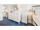 Bedroom with white dresser, gold accents, and blue carpet at 2500 Ocean Blvd. N # 1014, North Myrtle Beach, SC 29582