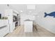 Condo kitchen with white cabinetry, stainless steel appliances, and breakfast bar at 2500 Ocean Blvd. N # 1014, North Myrtle Beach, SC 29582