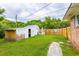 A fenced backyard features a storage shed and green grass at 705 White Oak Dr., Johnsonville, SC 29555