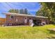 Backyard showing a brick house with a metal roof and shed at 705 White Oak Dr., Johnsonville, SC 29555
