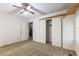 Bedroom with carpet flooring, standard closet, adjacent empty room, and fan at 705 White Oak Dr., Johnsonville, SC 29555