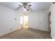 Comfortable bedroom with carpet flooring, ample natural light, and a ceiling fan at 705 White Oak Dr., Johnsonville, SC 29555