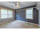 Bright bedroom with two windows, ceiling fan, and built-in shelving at 705 White Oak Dr., Johnsonville, SC 29555