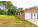 Exterior view of the house featuring a brick facade, green lawn, and driveway at 705 White Oak Dr., Johnsonville, SC 29555