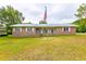 Charming brick home featuring an American flag, well-maintained lawn, and a classic design at 705 White Oak Dr., Johnsonville, SC 29555