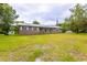 Traditional single-story brick home with a metal roof, a well-maintained lawn, and mature trees in the yard at 705 White Oak Dr., Johnsonville, SC 29555
