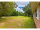 House front yard view, showing road and trees at 705 White Oak Dr., Johnsonville, SC 29555