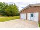 Detached garage with white door and large driveway at 705 White Oak Dr., Johnsonville, SC 29555