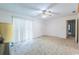 Bright living room with neutral carpet, large windows, and a ceiling fan for comfortable living at 705 White Oak Dr., Johnsonville, SC 29555