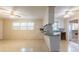 Open-concept living space featuring tiled floor, large windows, and a view into the kitchen area at 705 White Oak Dr., Johnsonville, SC 29555