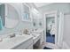 Bathroom with double vanity and view into bedroom at 5207 Ocean Blvd. N, North Myrtle Beach, SC 29582