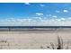 Expansive beach view with clear blue sky and ocean waves at 1509 Crooked Hook Rd., North Myrtle Beach, SC 29582