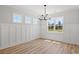 Bright dining room featuring wainscoting and a chandelier at 1509 Crooked Hook Rd., North Myrtle Beach, SC 29582