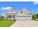 Two-story house with three-car garage and landscaped yard at 1509 Crooked Hook Rd., North Myrtle Beach, SC 29582