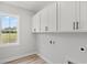 Laundry room with upper cabinets and a window at 1509 Crooked Hook Rd., North Myrtle Beach, SC 29582