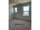 Well-lit bedroom featuring carpet and dual windows at 1327 Winding Creek Way, Myrtle Beach, SC 29588