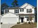 Two-story house with white siding, a two-car garage, and landscaping at 1327 Winding Creek Way, Myrtle Beach, SC 29588