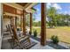 Relaxing front porch with rocking chairs and view of the backyard at 2192 Eastwoods Dr., Conway, SC 29526