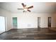 Living room with hardwood floors, ceiling fan, and multiple doorways at 110 South Shore Blvd. # 202, Longs, SC 29568