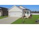 Newly built home with a two-car garage and well-manicured lawn at 773 Cypress Preserve Circle, Longs, SC 29568