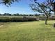 Beautiful backyard with large green grassy area and walkway leading to the water at 118 Salt Marsh Circle # 25B, Pawleys Island, SC 29585