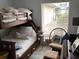 Comfortable bunk beds next to a window, styled with pillows and side table at 118 Salt Marsh Circle # 25B, Pawleys Island, SC 29585