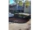 Charming condo building with grey siding, featuring private balconies and mature landscaping at 118 Salt Marsh Circle # 25B, Pawleys Island, SC 29585