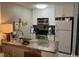 Modern kitchen featuring stainless steel appliances, granite counters and white cabinetry at 118 Salt Marsh Circle # 25B, Pawleys Island, SC 29585