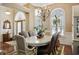 Elegant dining room boasting a chandelier and large windows with natural light at 2000 Kilkee Dr., Myrtle Beach, SC 29579