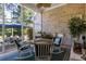 Inviting screened porch with brick wall, fan, and cozy seating area with an exterior view at 2000 Kilkee Dr., Myrtle Beach, SC 29579