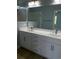 A bathroom with a double sink vanity with a marble countertop and a walk-in shower at 1738 Cenith Dr., North Myrtle Beach, SC 29582