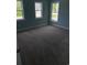 A carpeted bedroom featuring three windows and light blue walls at 1738 Cenith Dr., North Myrtle Beach, SC 29582
