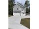Charming two-story home with a gray exterior, white trim, an attached garage, and a concrete driveway at 1738 Cenith Dr., North Myrtle Beach, SC 29582