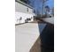 Rear view of a gray two-story home with a concrete patio, surrounded by privacy fencing and mature trees at 1738 Cenith Dr., North Myrtle Beach, SC 29582