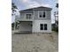 Charming gray two-story home with a balcony, complemented by verdant surroundings in a quiet neighborhood setting at 1738 Cenith Dr., North Myrtle Beach, SC 29582
