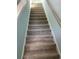 Carpeted staircase with wooden handrail, offering a safe and stylish transition between levels of the home at 1738 Cenith Dr., North Myrtle Beach, SC 29582